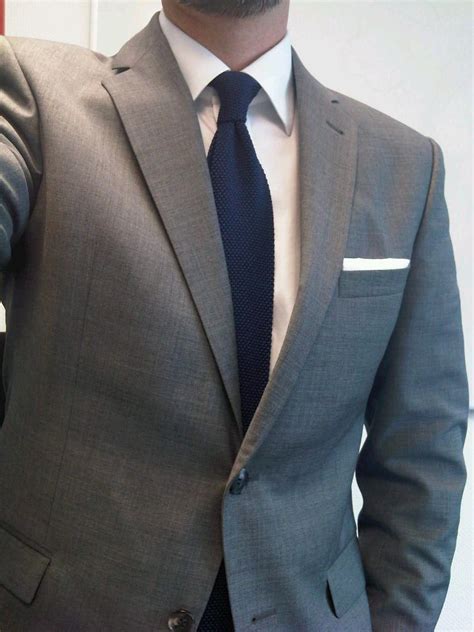 dark grey suit navy tie.